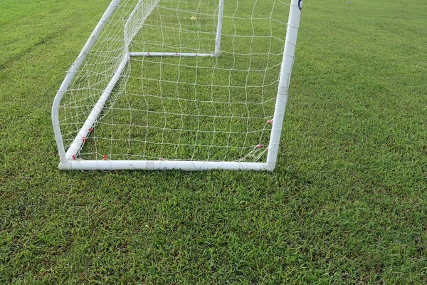 White soccer goal on the football field