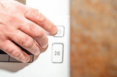 Turning on the start button on the washing machine. The concept of doing laundry. Washing dirty clothes, starting the washing machine, setting parameters.