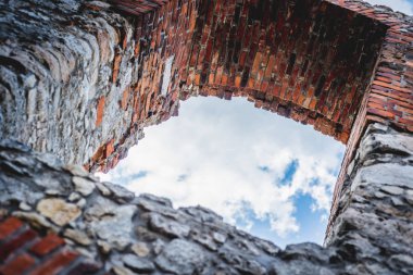 Window frame with a view from the castle. Ruins of a medieval castle. Old castle. A stronghold made of stone on the hill.
