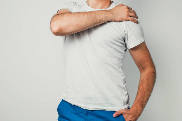 Neck pain. The man is holding his neck. Health and medical concept.