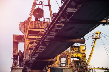 Industrialism. View of an old, rusty mine machine, excluded from use on coal heaps. Coal conveyor in Silesia in Poland.