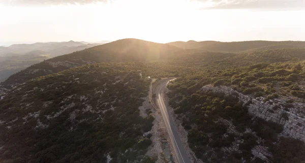 Top view of a road on the mountain top at sunset.