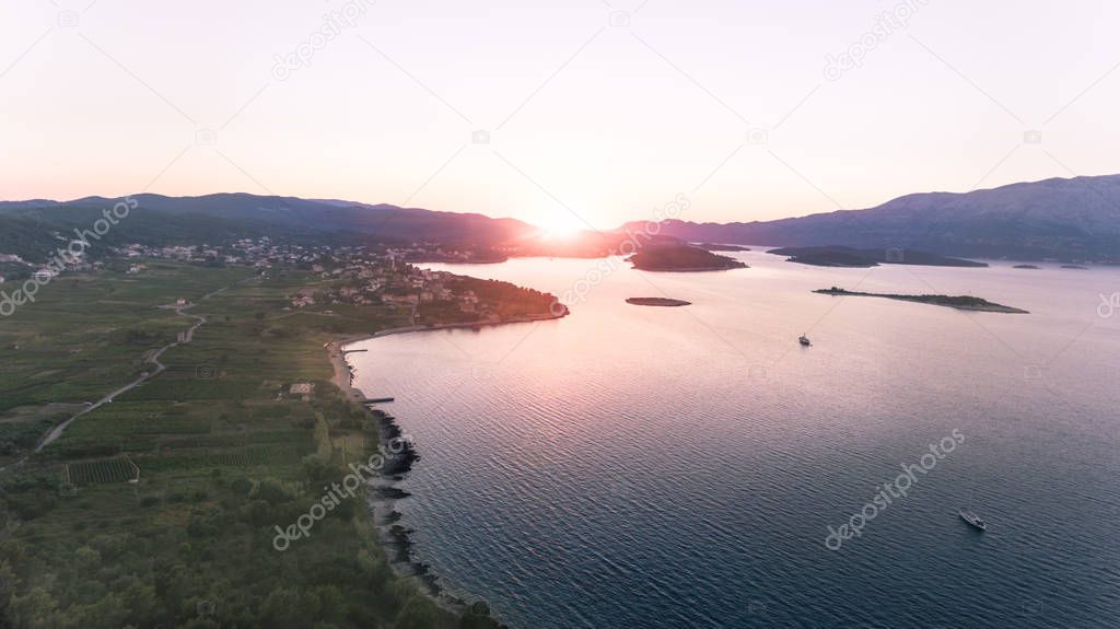 Aerial view of a beautiful sunset behind the popular island of Korcula