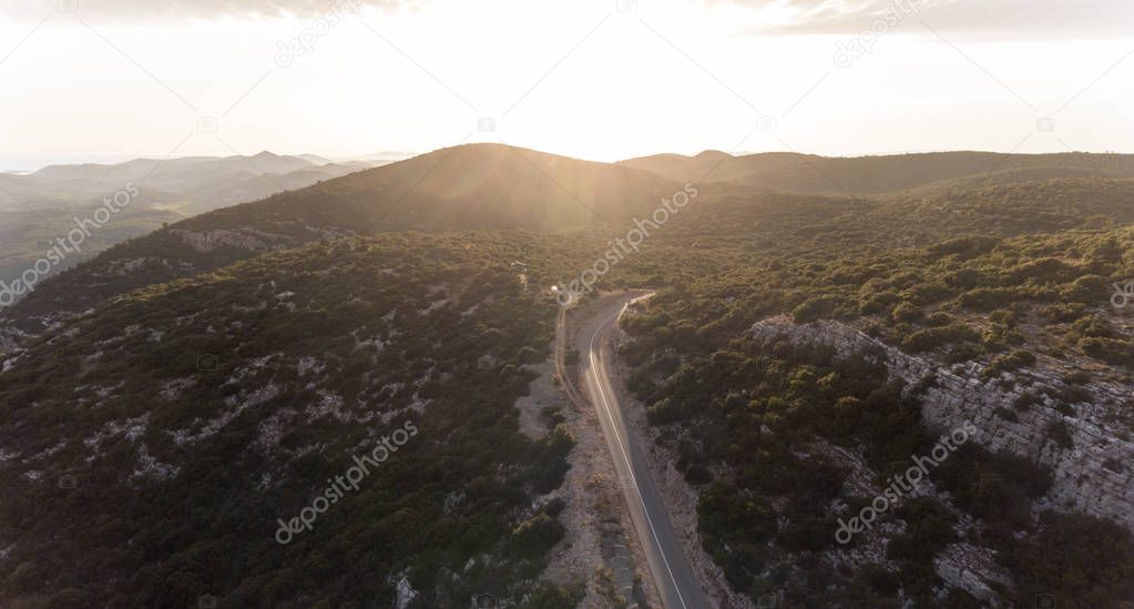 Top view of a road on the mountain top at sunset.