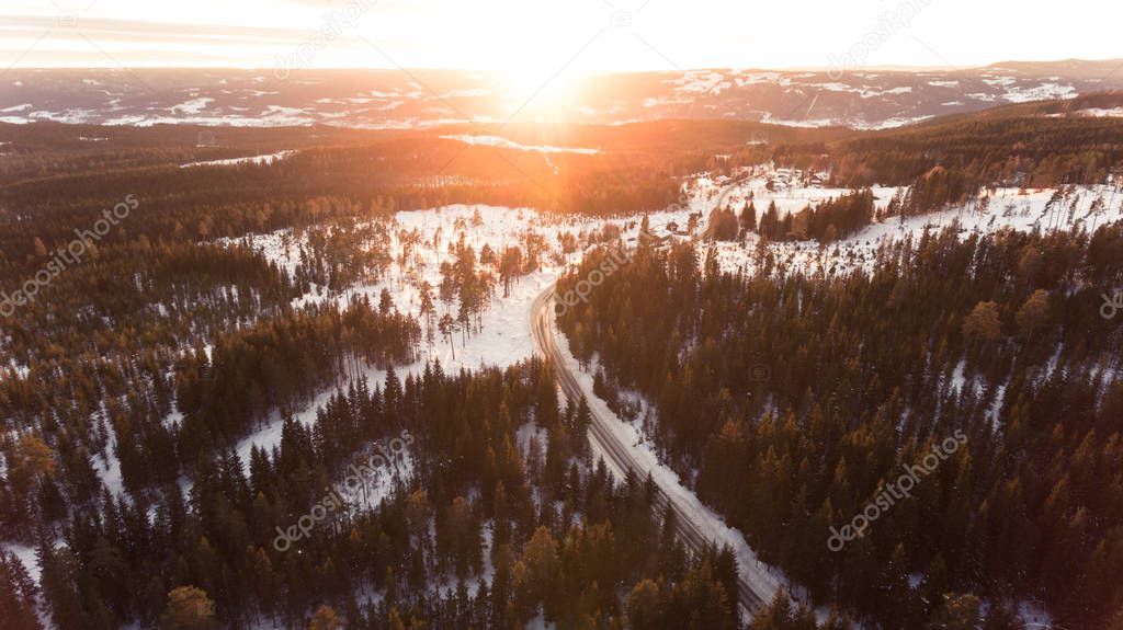 Aerial view of winding road in beautiful snowy winter landscape. Winter wonderland. 