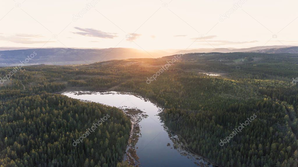 Aerial view of beautiful evening in the nature. Forest and lake 