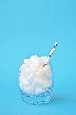 Şeker küpleriyle dolu bir kavanoz sağlıksız bir diyetin ve şeker dolu sağlıksız gıdaların sembolü. Nüfusa aşırı şeker vermek için konsept.