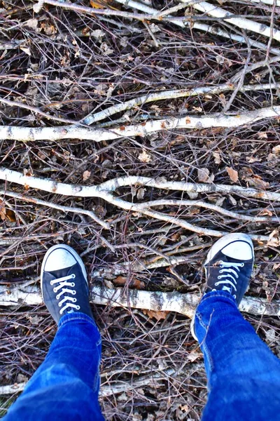 feet of man in gum shoes on nature background