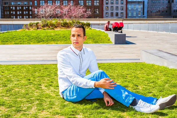 American Man Relaxing on Green Lawn in New York