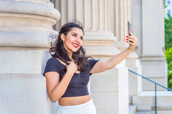 American teenage girl taking picture of her self with cell phone