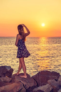 Genç kadın izlerken günbatımı