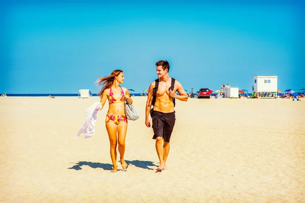 Young American Couple traveling, relaxing on the beach in New Je