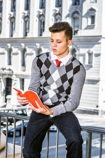 Young American Man Reading Outside in New York