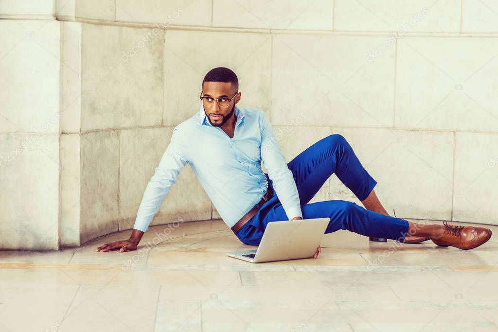 Young African American Man with beard working on laptop computer