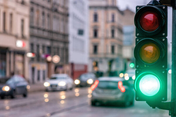 A city crossing with a semaphore. Green light in semaphore