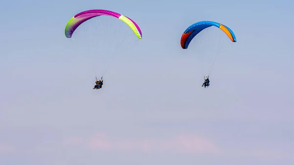 Geneva, Switzerland - April 14, 2019: Paragliding in Swiss Alps over the mountains against clear blue sky — 스톡 사진