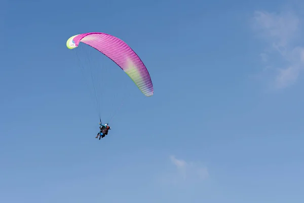 Geneva, Switzerland - April 14, 2019: Paragliding in Swiss Alps over the mountains against clear blue sky — Stock Photo, Image