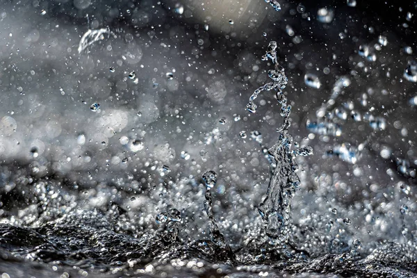 Water splash with small drops in the fountain. Abstract natural, selective focus  background — Stock Photo, Image