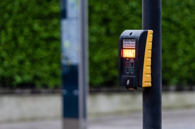 Yayalar için yaya geçidi düğmesi. Odaklanmamış arka planda ışık uyarısı var. Londra, Uk