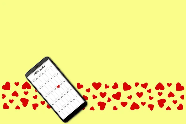 Valentine day concept, on yellow background isolated red paper hearts and smartphone with calendar on screen — Stockfoto