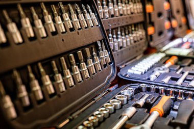Box with special tools in car repair shop, closeup, selective focus