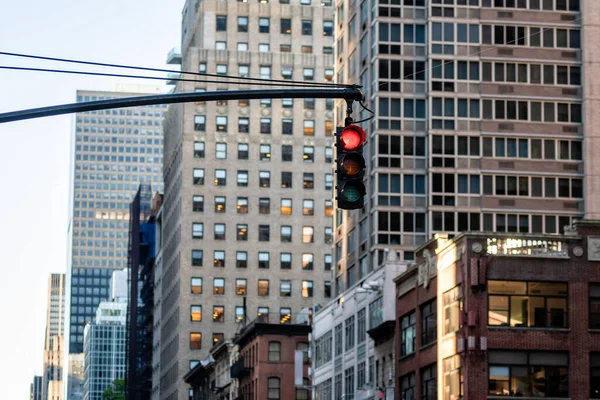 Traffic light with red light above Manhatan street among many skyscrapers, New York, USA — Stock Photo, Image