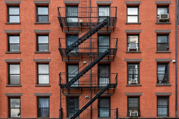bricks buildings facades with fire escape stairs