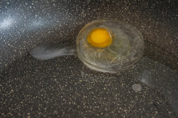 frozen bull\'s eye egg cooked on a non-stick pan that cooks slowly