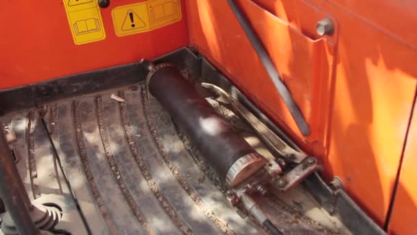 View of a cabin of an excavator with danger symbols and instructions and the seat all broken and used with controls and cloches — Stock Video