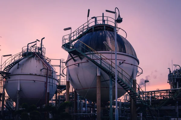 Gas storage sphere tanks in petrochemical industry with sunset sky background