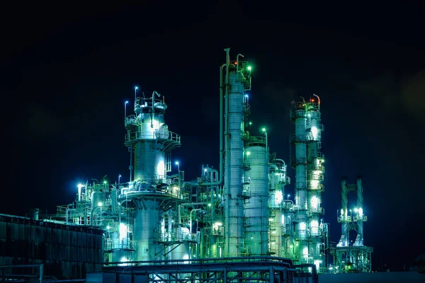 Glitter lighting of industrial plant at night, Tower of oil and gas refinery plant, Manufacturing petrochemical plant