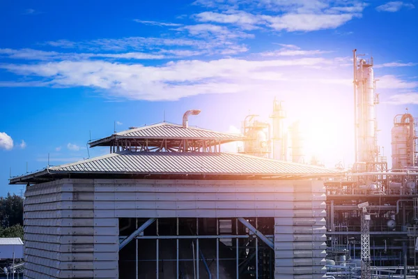 Factory building of petrochemical plant with sunset sky background