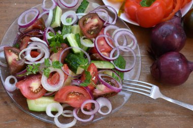 summer vegetables salad in glass bowl on table 