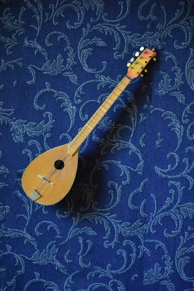 Closeup View Lute Musical Instrument Blue Textile Background — стоковое фото