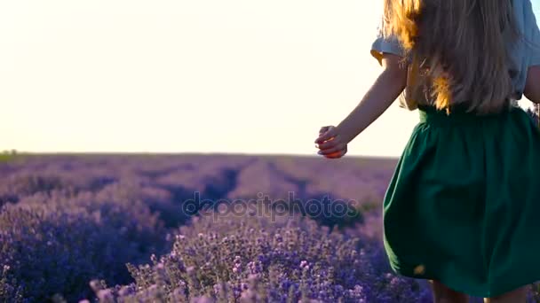 Happy Young Beautiful Woman Running Through Lavender Field in White shirt and green Dress