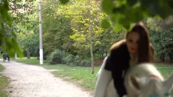 Молода усміхнена брюнетка Джокі дівчина верхи на коні в парку — стокове відео