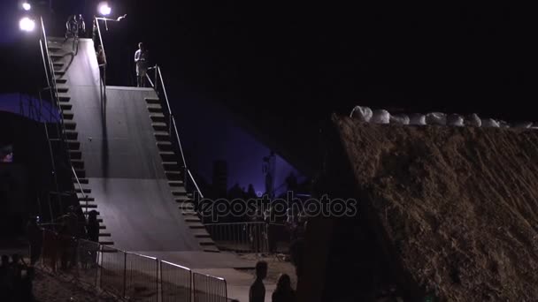 Realtidsvideo av extrema man idrottare gör ett tillbaka Flip trick på den Mtb Bmx cykel medan Dirtjumping på natten på den festivalen extrema Ukraina 2017 — Stockvideo