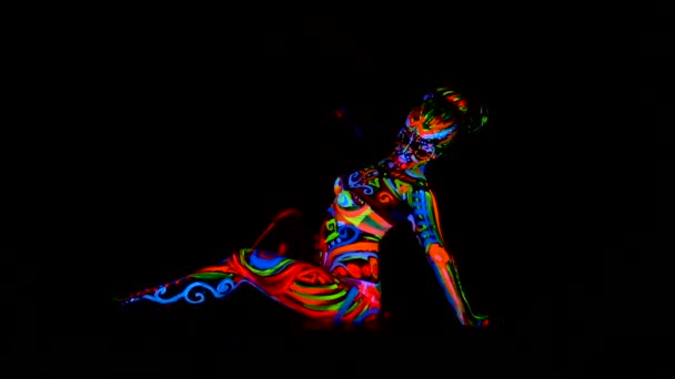 Beautiful young sexy girl in lingerie dancing with ultraviolet paint on her body. Girl with neon bodyart in color light. — Stock Video