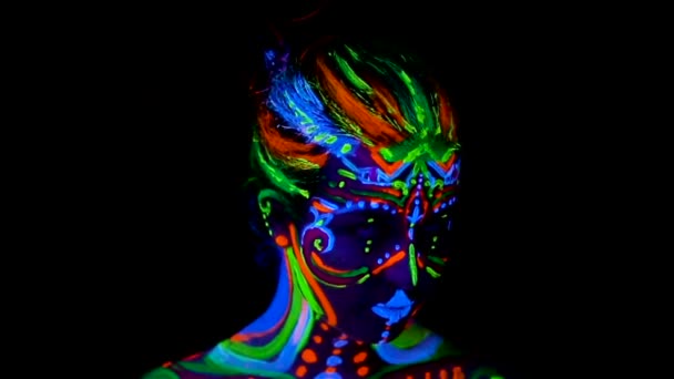 Beautiful young sexy girl in lingerie dancing with ultraviolet paint on her body. Girl with neon bodyart in color light. — Stock Video