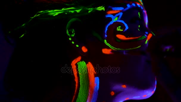 Ультрафиолетовый художник рисует на коже красивой молодой сексуальной девушки . — стоковое видео