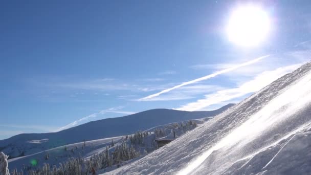Снежная метель в горах в прекрасную солнечную погоду — стоковое видео