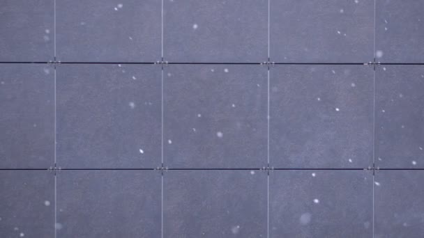 Snow flakes falling on a Gray Tile background, Snowfall, snowflakes, winter background. — Stock Video