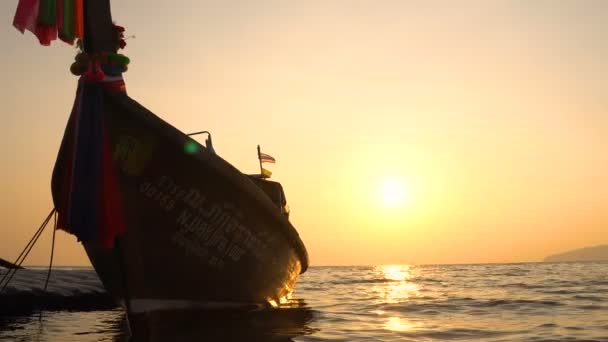 Rybář thajské dřevěné plachetnice lodní silueta plovoucí na moři obzoru. Úžasné barvy tropických Sunset. — Stock video