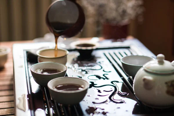 Pouring of Puer Tea from Gaiwan at Traditional Chinese Tea Ceremony. Set of Equipment for Drinking Tea — Stock Photo, Image