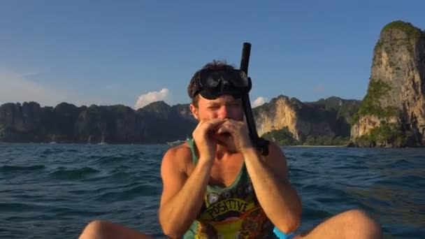 Homem tocando harpa em caiaque na água do mar aberto em máscara e tubo para mergulho ou snorkel. Railey Beach, Krabi, Tailândia . — Vídeo de Stock