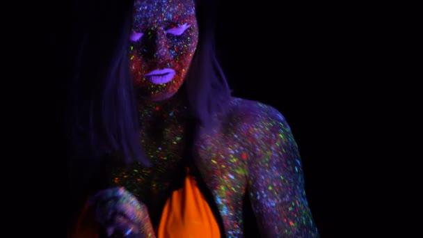 Neon Uv ışık güzel moda kadın portresi. Floresan yaratıcı Psychedelic makyaj, sanat tasarım Uv kadın disko dansçısı modelinin model kızla — Stok video