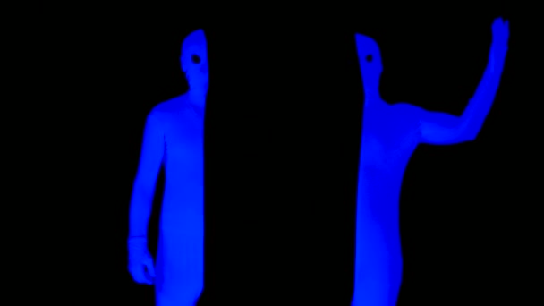 UV-Strahlung halbiert die pantomimische Interaktion. Die eine Hälfte legt Hand in Hand in eine andere, kontrastreiche Komödie. Blau auf schwarz Szene im Schwarzlicht. — Stockvideo