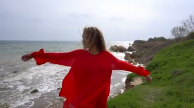 Mutlu genç kadın kırmızı çember elbise ve Yalı Cliff iyi eğlenceler