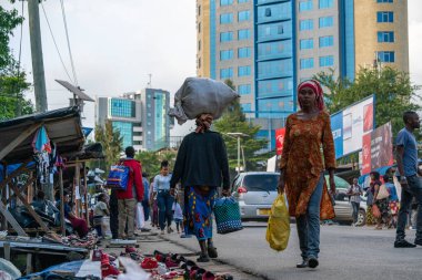 TANZANIA, ARUSHA - 15 Jan 2020: Carry good on the head is african skill. People on the street in Arusha city, Tanzania