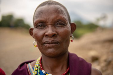 TANZANIA, MASAI VILLAGE - JANUARY 2020: Portrait of Maasai woman people in native masai village Engare Sero on the coast of Natron Lake in Maasailand, Arusha district
